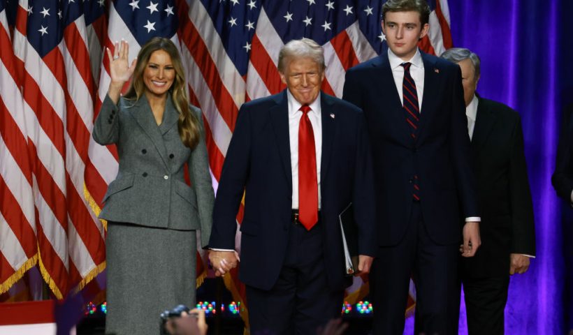 WEST PALM BEACH, FLORIDA - NOVEMBER 06: Republican presidential nominee, former U.S. President Donald Trump arrives to speak with former first lady Melania Trump and Barron Trump during an election night event at the Palm Beach Convention Center on November 06, 2024 in West Palm Beach, Florida. Americans cast their ballots today in the presidential race between Republican nominee former President Donald Trump and Vice President Kamala Harris, as well as multiple state elections that will determine the balance of power in Congress. (Photo by Joe Raedle/Getty Images)