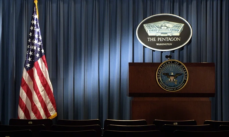 399192 06: The Pentagon logo and an American flag are lit up January 3, 2002 in the briefing room of Pentagon in Arlington, VA. (Photo by Alex Wong/Getty Images)