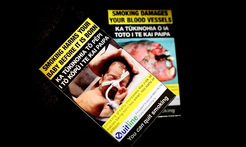 In this photo illustration plain cigarette packaging can be seen on March 15, 2018 in Auckland, New Zealand. As of 14 March 2018, legislation prevents tobacco companies using branding on their cigarette packaging. After a 12 week 'wash out' phase to allow existing stock to be sold as plain packaging is introduced. Moving forward tobacco packets will be the same standard brown or green, with graphic pictures and health warnings enlarged to cover at least 75% of the front of tobacco packs, and all tobacco company marketing imagery removed. (Photo by Hannah Peters/Getty Images)