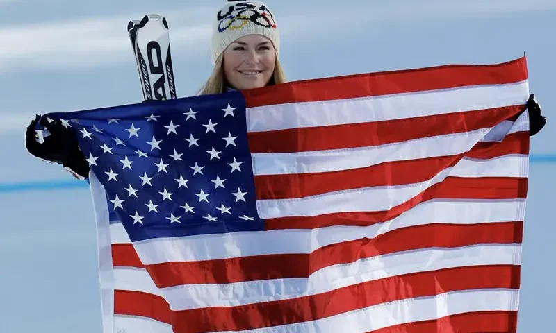 Lindsey Vonn holds a U.S flag after winning the gold medal in the women's Alpine Skiing Downhill race at the Vancouver 2010 Winter Olympics in Whistler, British Columbia February 17, 2010. REUTERS/Mike Segar/File Photo