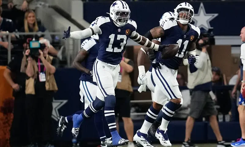 Dallas Cowboys linebacker DeMarvion Overshown (13) celebrates after scoring on a touchdown interception against the New York Giants during the first half at AT&T Stadium. Mandatory Credit: Chris Jones-Imagn Images