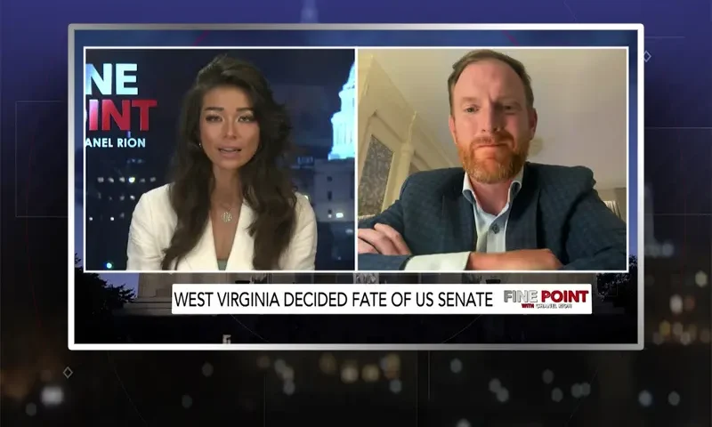 Video still from Fine Point on One America News Network showing a split screen of the host on the left side, and on the right side is the guest, JB McCuskey.