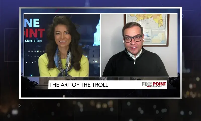 Video still from Fine Point on One America News Network showing a split screen of the host on the left side, and on the right side is the guest, George Santos.