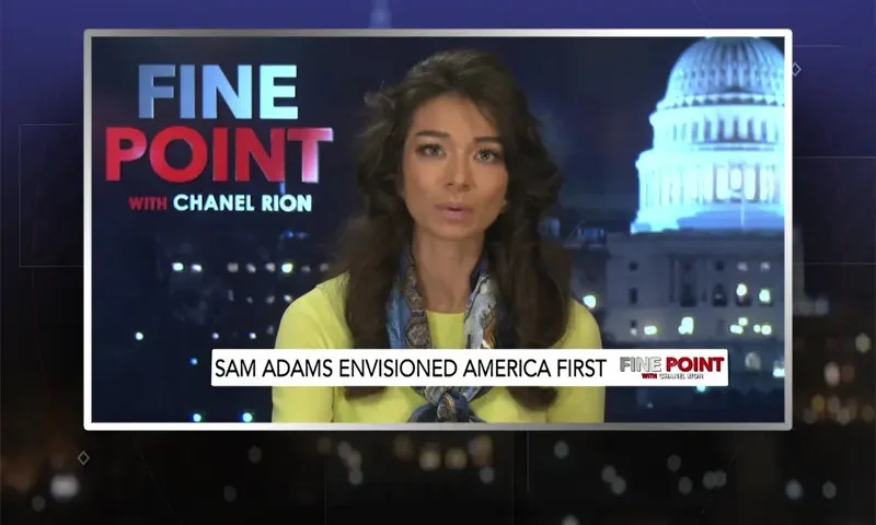 Video still of the host of Fine Point at the desk of their talk show on One America News Network.