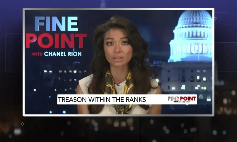 Video still of the host of Fine Point at the desk of their talk show on One America News Network.