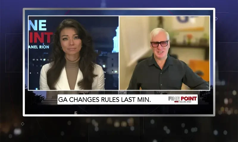 Video still from Fine Point on One America News Network showing a split screen of the host on the left side, and on the right side is the guest, Jim Hoft.