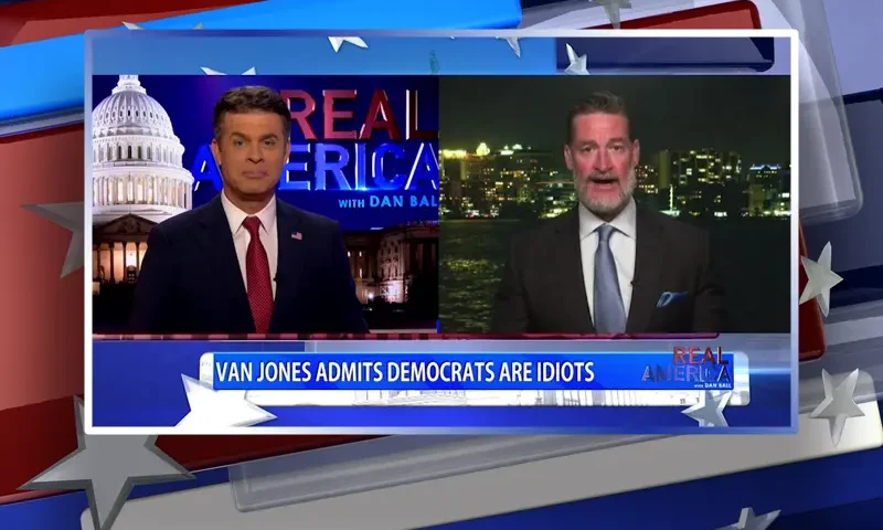 Video still from Real America on One America News Network showing a split screen of the host on the left side, and on the right side is the guest, Rep. Greg Steube.
