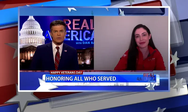 Video still from Real America on One America News Network showing a split screen of the host on the left side, and on the right side is the guest, Rep. Anna Paulina Luna.