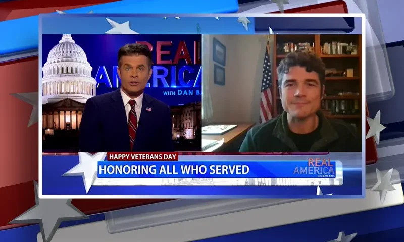 Video still from Real America on One America News Network showing a split screen of the host on the left side, and on the right side is the guest, Joe Kent.