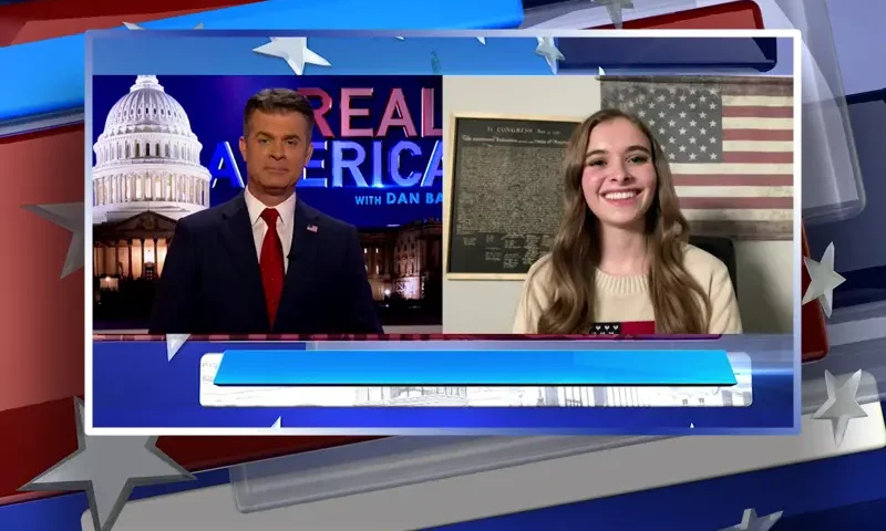 Video still from Real America on One America News Network showing a split screen of the host on the left side, and on the right side is the guest, Hannah Faulkner.