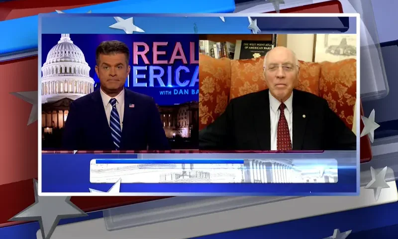 Video still from Real America on One America News Network showing a split screen of the host on the left side, and on the right side is the guest, Robert Maginnis.