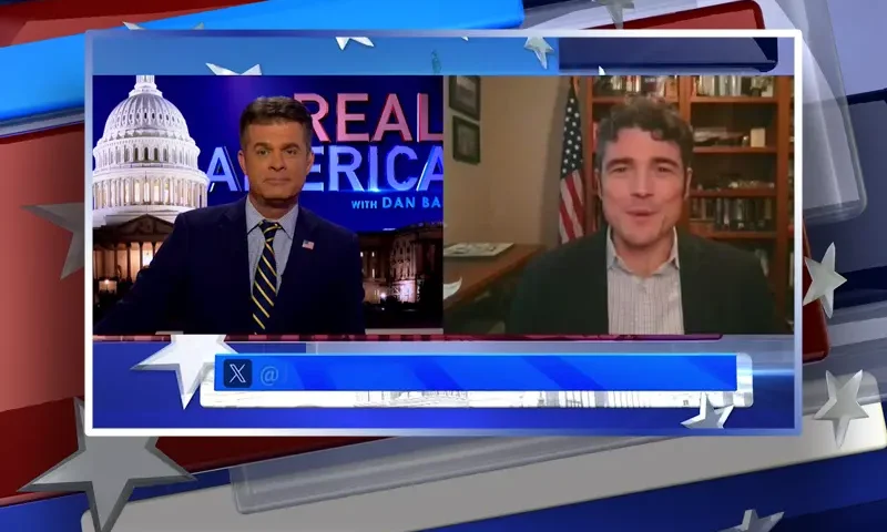 Video still from Real America on One America News Network showing a split screen of the host on the left side, and on the right side is the guest, Joe Kent.
