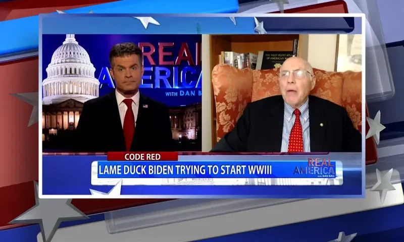 Video still from Real America on One America News Network showing a split screen of the host on the left side, and on the right side is the guest, Lt. Col. Robert Maginnis.