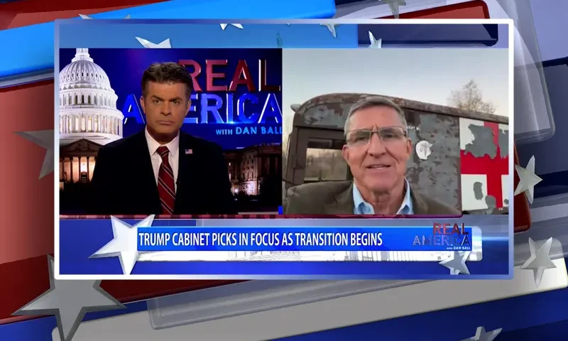 Video still from Real America on One America News Network showing a split screen of the host on the left side, and on the right side is the guest, General Michael Flynn.