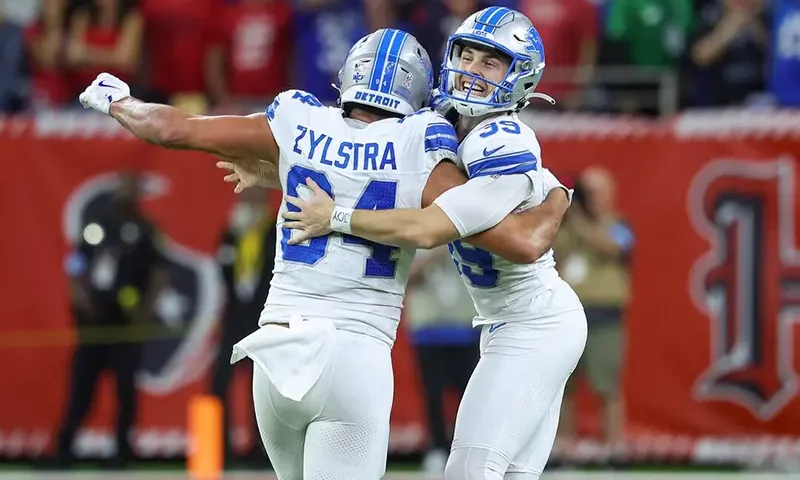Detroit Lions place kicker Jake Bates (39) celebrates with tight end Shane Zylstra (84) after kicking a field goal with time expiring to give the Lions a win over the Houston Texans at NRG Stadium. Mandatory Credit: Troy Taormina-Imagn Images