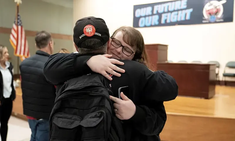 Members of the International Association of Machinists and Aerospace Workers District 751, embrace at a union hall after learning that union members voted to approve a new contract proposal from Boeing in Seattle, Washington, U.S. November 4, 2024. REUTERS/David Ryder Purchase Licensing Rights, opens new tab