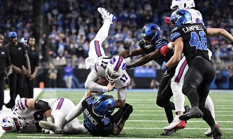 Buffalo Bills quarterback Josh Allen (17) goes airborne as he tries to dive for a first down against the Detroit Lions in the fourth quarter at Ford Field. Mandatory Credit: Lon Horwedel-Imagn Images