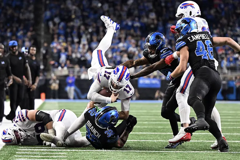 Buffalo Bills quarterback Josh Allen (17) goes airborne as he tries to dive for a first down against the Detroit Lions in the fourth quarter at Ford Field. Mandatory Credit: Lon Horwedel-Imagn Images