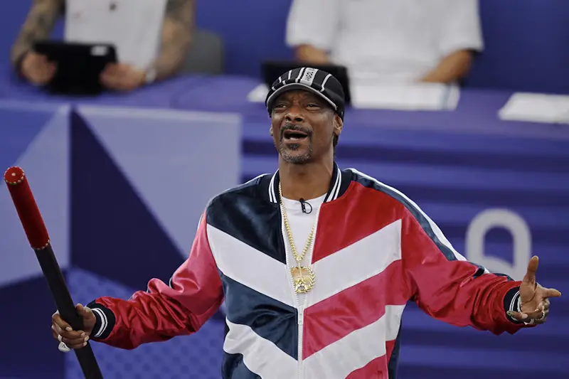 Snoop Dogg holds a baton to signal the official start of the competition. REUTERS/Angelika Warmuth/File Photo