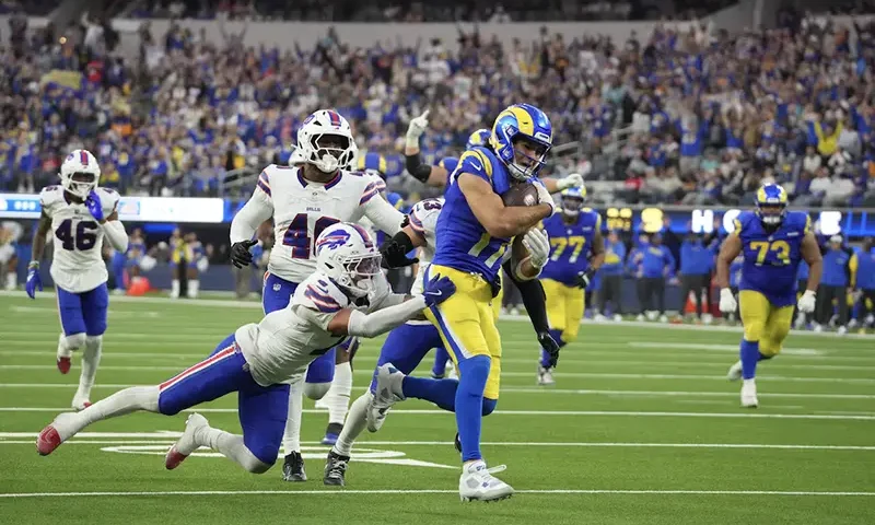 Los Angeles Rams wide receiver Puka Nacua (17) scores on a 19-yard touchdown reception against Buffalo Bills cornerback Taron Johnson (7), linebacker Von Miller (40) and linebacker Terrel Bernard (43) in the fourth quarter at SoFi Stadium. Mandatory Credit: Kirby Lee-Imagn Images