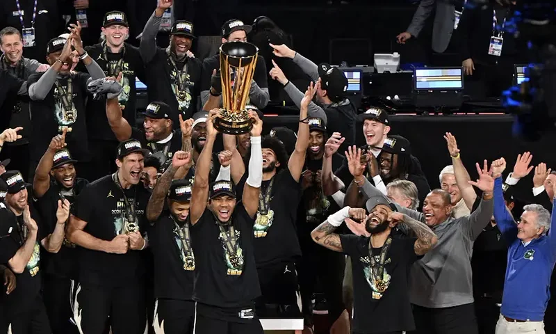 Milwaukee Bucks forward Giannis Antetokounmpo (34) lifts the trophy and celebrates with players and staff after winning the Emirates NBA Cup championship game against the Oklahoma City Thunder at T-Mobile Arena. Mandatory Credit: Candice Ward-Imagn Images