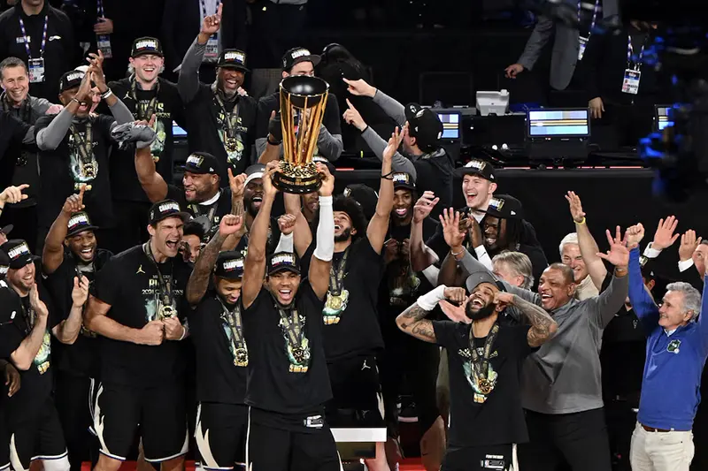 Milwaukee Bucks forward Giannis Antetokounmpo (34) lifts the trophy and celebrates with players and staff after winning the Emirates NBA Cup championship game against the Oklahoma City Thunder at T-Mobile Arena. Mandatory Credit: Candice Ward-Imagn Images