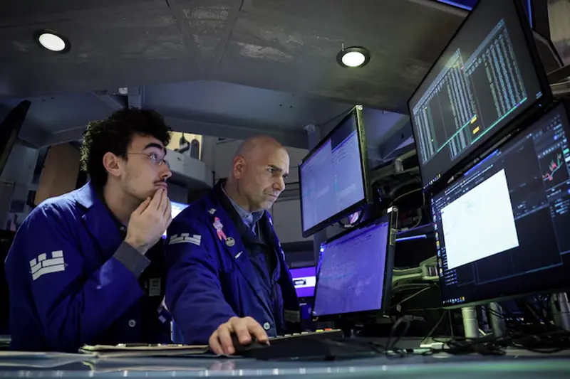Specialist traders work inside a post on the floor at the New York Stock Exchange (NYSE) in New York City, U.S., December 2, 2024. REUTERS/Brendan McDermid/File Photo