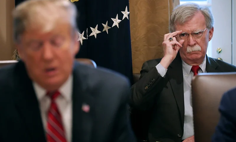 WASHINGTON, DC - FEBRUARY 12: National Security Advisor John Bolton (R) listens to U.S. President Donald Trump talk to reporters during a meeting of his cabinet in the Cabinet Room at the White House February 12, 2019 in Washington, DC. Trump said he was not happy about the compromise legislation agreed to by Republicans and Democrats that would prevent a new partial federal government shutdown but said he would accept the deal. (Photo by Chip Somodevilla/Getty Images)