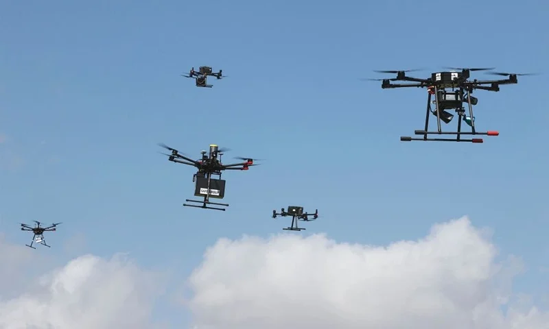 This picture taken on March 17, 2021 in the Israeli coastal city of Hadera shows several simultaneous flights of numerous unmanned aerial vehicles (UAVs, or drones) as part of the main demonstration performed by the companies who won the tender for the project. - Some 20 drones from five different companies will perform about 300 flights per day simultaneously in a mesh network managed by an autonomous control system located at the Ayalon Highways Aerial Control Center in Haifa. (Photo by JACK GUEZ / AFP) (Photo by JACK GUEZ/AFP via Getty Images)