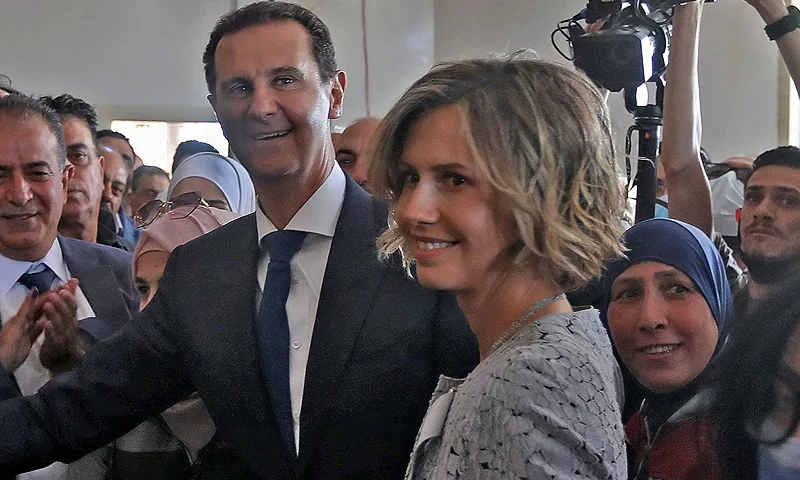 TOPSHOT - Syrian President Bashar al-Assad (C) and his wife Asma (R) cast their votes at a polling station in Douma, near Damascus on May 26, 2021, as voting began across Syria for an election guaranteed to return Assad for a fourth term in office. - The 55-year-old president, who has been in power since 2000, is sure to keep his job after the election, every aspect of which is controlled by him and his Baath party. He faces former state minister Abdallah Salloum Abdallah and Mahmoud Merhi, a member of the so-called "tolerated opposition", long described by exiled opposition leaders as an extension of the regime. (Photo by LOUAI BESHARA / AFP) (Photo by LOUAI BESHARA/AFP via Getty Images)