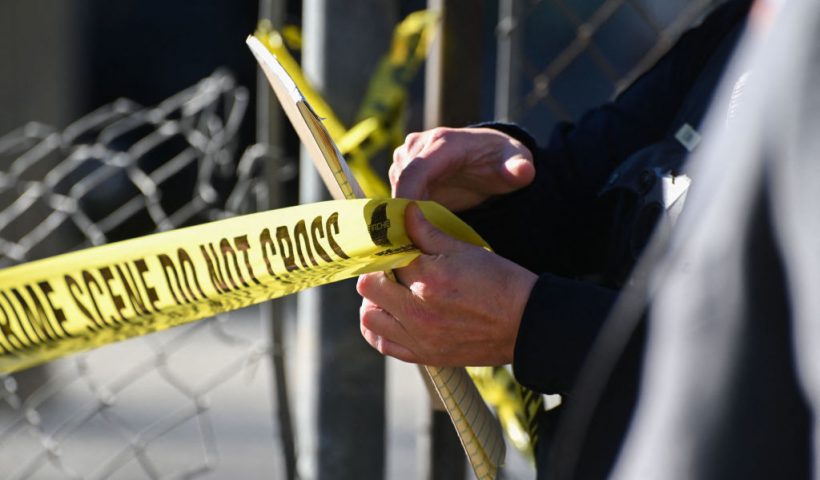 A San Mateo County Sheriff officer puts up police tape at a crime scene after a shooting at the Spanish Town shops in Half Moon Bay, California, on January 24, 2023. - A suspected gunman was in custody Monday over the killing of seven people in a rural community in northern California, just two days after a mass shooting at a Lunar New Year celebration near Los Angeles. (Photo by Samantha Laurey / AFP) (Photo by SAMANTHA LAUREY/AFP via Getty Images)