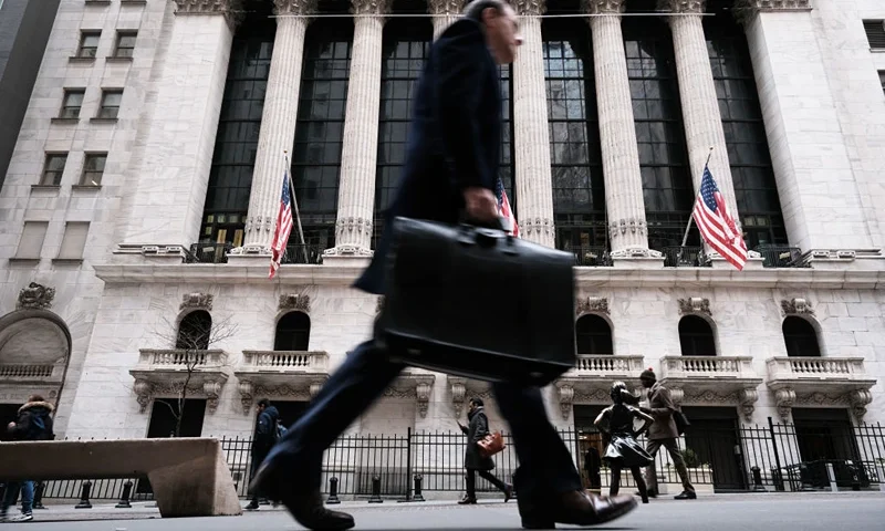NEW YORK, NEW YORK - MARCH 16: People walk past the New York Stock Exchange (NYSE) on March 16, 2023 in New York City. Stocks fell again in morning trading as investors continue to show concerns over the stability of global banks following the collapse last week of Silicon Valley Bank. (Photo by Spencer Platt/Getty Images)