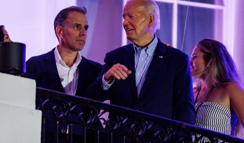 WASHINGTON, DC - JULY 04: President Joe Biden talks to his son, Hunter Biden, following the fireworks on the National Mall with First Lady Jill Biden and Second Gentleman Doug Emhoff from the White House balcony during a 4th of July event on the South Lawn of the White House on July 4, 2024 in Washington, DC. The President is hosting the Independence Day event for members of the military and their families. (Photo by Samuel Corum/Getty Images)