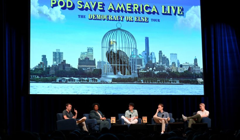 NEW YORK, NEW YORK - JUNE 26: (L-R) Jon Favreau, Stacey Abrams, Jon Lovett, Tommy Vietor and Daniel Pfeiffer speak onstage during the Crooked Media – Pod Save America: The Democracy or Else Tour at Brooklyn Paramount on June 26, 2024 in New York City. (Photo by Slaven Vlasic/Getty Images for Crooked Media)