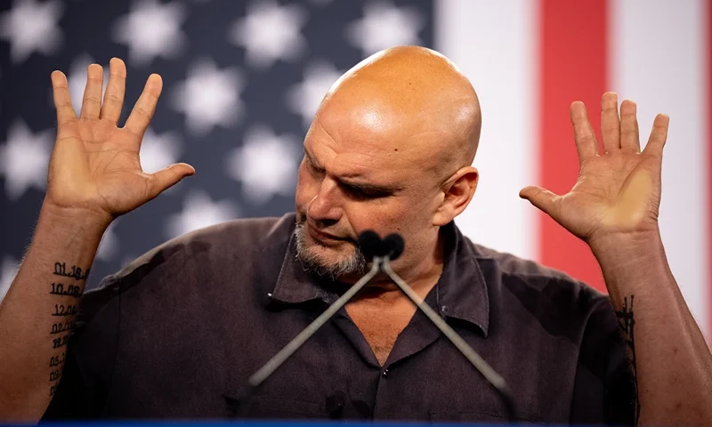 YORK, PENNSYLVANIA - OCTOBER 2: Sen. John Fetterman (D-PA) gestures while speaking at a rally for Democratic vice presidential nominee Minnesota Gov. Tim Walz at York Exposition Center UPMC Arena on October 2, 2024 in York, Pennsylvania. Walz is holding a rally a day after debating Republican vice presidential Nominee Sen. JD Vance (R-OH) at the CBS Broadcast Center in New York City. (Photo by Andrew Harnik/Getty Images)