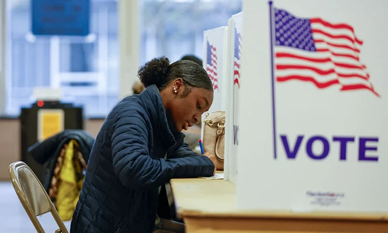 TOPSHOT - A woman casts her ballot during early voting for the US general election at a polling station at Ottawa Hills High School in Grand Rapids, Michigan, on November 3, 2024. (Photo by KAMIL KRZACZYNSKI / AFP) (Photo by KAMIL KRZACZYNSKI/AFP via Getty Images)