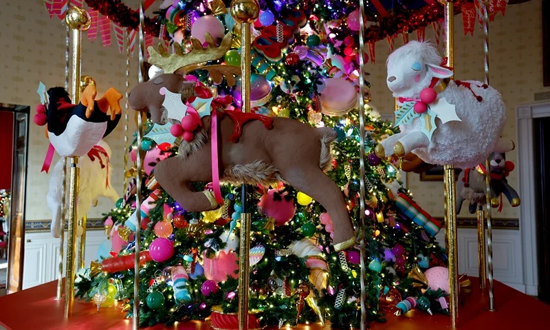 A carousel surrounds the White House Christmas Tree during a media preview of the 2024 holiday decorations at the White House on December 02, 2024 in Washington, DC. The theme for this year's White House holiday decorations is “Season of Peace and Light.” (Photo by Anna Moneymaker/Getty Images)