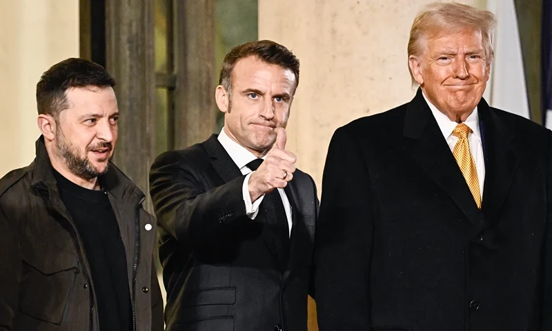 France's President Emmanuel Macron (C) thumbs up flanked by US president-elect Donald Trump (RO and Ukraine's President Volodymyr Zelensky (2nd L) after a meeting at The Elysee Presidential Palace in Paris on December 7, 2024. Trump makes his first international trip since his election win, preparing for a day of intense diplomacy before attending the reopening ceremony for the Notre Dame cathedral restored after the 2019 fire. (Photo by JULIEN DE ROSA / AFP) (Photo by JULIEN DE ROSA/AFP via Getty Images)
