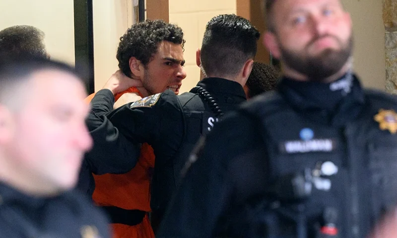 HOLLIDAYSBURG, PENNSYLVANIA - DECEMBER 10: Suspected shooter Luigi Mangione is led into the Blair County Courthouse for an extradition hearing December 10, 2024 in Hollidaysburg, Pennsylvania. Mangione has been arraigned on weapons and false identification charges related to the fatal shooting of United Healthcare CEO Brian Thompson in New York City. Mangione is incarcerated in the State Correctional Institution in Huntingdon, Pennsylvania awaiting extradition to New York. (Photo by Jeff Swensen/Getty Images)