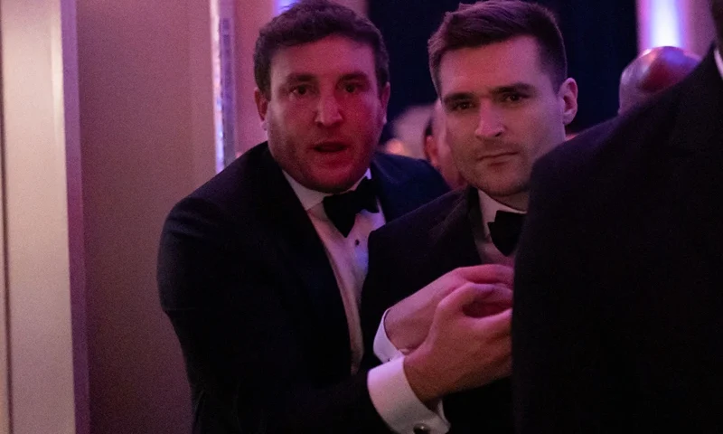 US political strategist Alex Bruesewitz (C) is escorted backstage after collapsing on stage while speaking during the New York Young Republican Club's Annual Gala at Cipriani's Wall Street in New York City on December 15, 2024. (Photo by Adam GRAY / AFP) (Photo by ADAM GRAY/AFP via Getty Images)