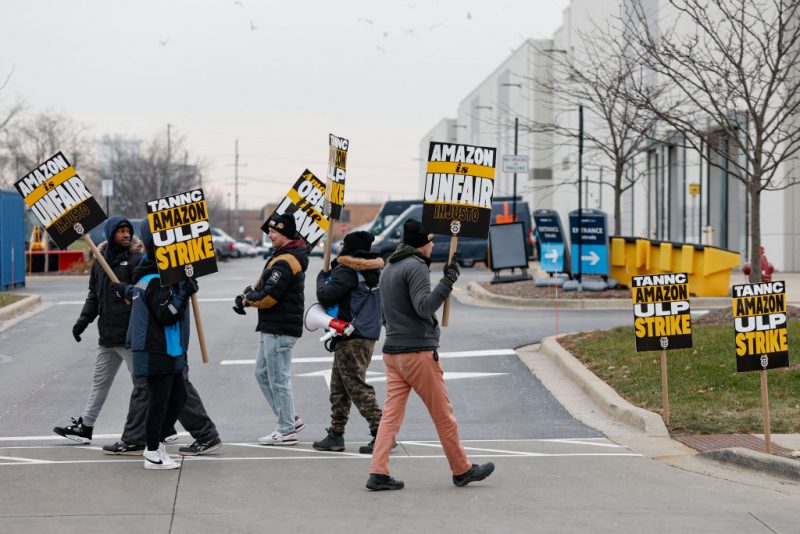 Amazon delivery drivers walk the picket line outside Amazon delivery station as they went on strike in Skokie, Illinois on December 19 2024. Thousands of workers at Amazon facilities across the United States went on strike Thursday, the Teamsters Union said, halting work at the height of the busy holiday gift-giving season. (Photo by KAMIL KRZACZYNSKI / AFP) (Photo by KAMIL KRZACZYNSKI/AFP via Getty Images)