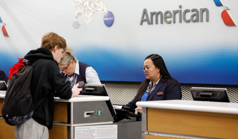 American Airlines agent assists a traveler at O'Hare International Airport in Chicago, Illinois, on December 20, 2024 ahead of the upcoming Christmas holiday. Based on estimates from air carries 3.66 million passenger will travel through O'Hare and Midway International Airports in Chicago between December 20 and January 2. (Photo by KAMIL KRZACZYNSKI / AFP) (Photo by KAMIL KRZACZYNSKI/AFP via Getty Images)