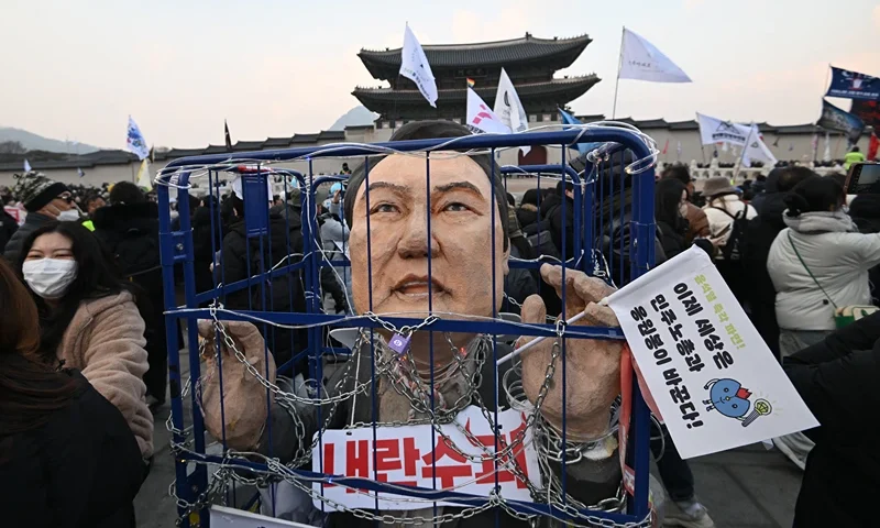 An effigy of South Korea's impeached President Yoon Suk Yeol is seen in a mock prison as protesters take part in a rally calling for Yoon's ouster in front of the Gwanghwamun Gate of Gyeongbokgung Palace in Seoul on December 21, 2024. (Photo by Jung Yeon-je / AFP) (Photo by JUNG YEON-JE/AFP via Getty Images)