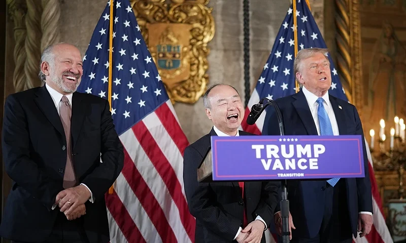 PALM BEACH, FLORIDA - DECEMBER 16: SoftBank CEO Masayoshi Son delivers remarks alongside U.S. President-elect Donald Trump and Trump's choice for Secretary of Commerce, Cantor Fitzgerald Chairman and CEO Howard Lutnick (L) at Trump’s Mar-a-Lago resort on December 16, 2024 in Palm Beach, Florida. Trump announced that SoftBank will invest over $100 billion in projects in the United States including 100,000 artificial intelligence related jobs. (Photo by Andrew Harnik/Getty Images)