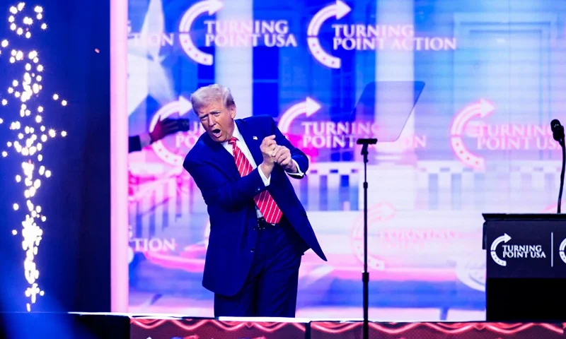 US President-elect Donald Trump mimics a golf swing onstage while speaking during Turning Point's annual AmericaFest 2024 in Phoenix, Arizona, on December 22, 2024. (Photo by JOSH EDELSON / AFP) (Photo by JOSH EDELSON/AFP via Getty Images)