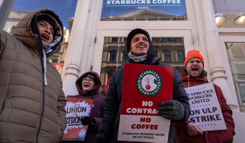 NEW YORK, NEW YORK - DECEMBER 23: Starbucks employees, union members and supporters strike outside of a Starbuck store which is closed down due to the strike on December 23, 2024 in New York City. Starbucks Workers United stated that union workers in Missouri, New Jersey, and New York started their strike on Sunday, following the participation of locations in Colorado, Ohio, and Pennsylvania on Saturday. The union represents over 10,000 employees across more than 525 stores. (Photo by Adam Gray/Getty Images)
