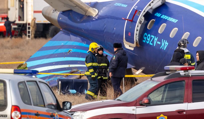 TOPSHOT - Emergency specialists work at the crash site of an Azerbaijan Airlines passenger jet near the western Kazakh city of Aktau on December 25, 2024. The Embraer 190 aircraft was supposed to fly northwest from the Azerbaijani capital Baku to the city of Grozny in Chechnya in southern Russia, but instead diverted far off course across the Caspian Sea. It crashed on December 25, 2024 near the city of Aktau in Kazakhstan. (Photo by Issa Tazhenbayev / AFP) (Photo by ISSA TAZHENBAYEV/AFP via Getty Images)