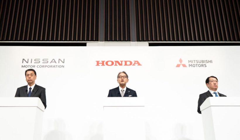 TOKYO, JAPAN - DECEMBER 23: Nissan Motor CEO Makoto Uchida (L), Honda Motor CEO Toshihiro Mibe (C) and Mitsubishi Motors President Takao Kato (R) attend a joint press conference on December 23, 2024, in Tokyo, Japan. Nissan and Honda announced they have begun merger negotiations, aiming to create the world's third-largest automotive group to compete with rival EV manufacturers such as China's BYD and the US-based Tesla. (Photo by Tomohiro Ohsumi/Getty Images)