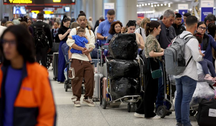 MIAMI, FLORIDA - DECEMBER 23: Travelers wait to check in for their flights at the Miami International Airport on December 23, 2024 in Miami, Florida. TSA expects to screen about 40 million passengers through airport checkpoints during the holidays that run through Jan. 2. (Photo by Joe Raedle/Getty Images)