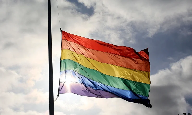 A pride flag stands a half mast during a memorial service in San Diego, California on June 12, 2016, for the victims of the Orlando Nighclub shooting. Fifty people died when a gunman allegedly inspired by the Islamic State group opened fire inside a gay nightclub in Florida, in the worst terror attack on US soil since September 11, 2001. (Photo by Sandy Huffaker / AFP) (Photo by SANDY HUFFAKER/AFP via Getty Images)